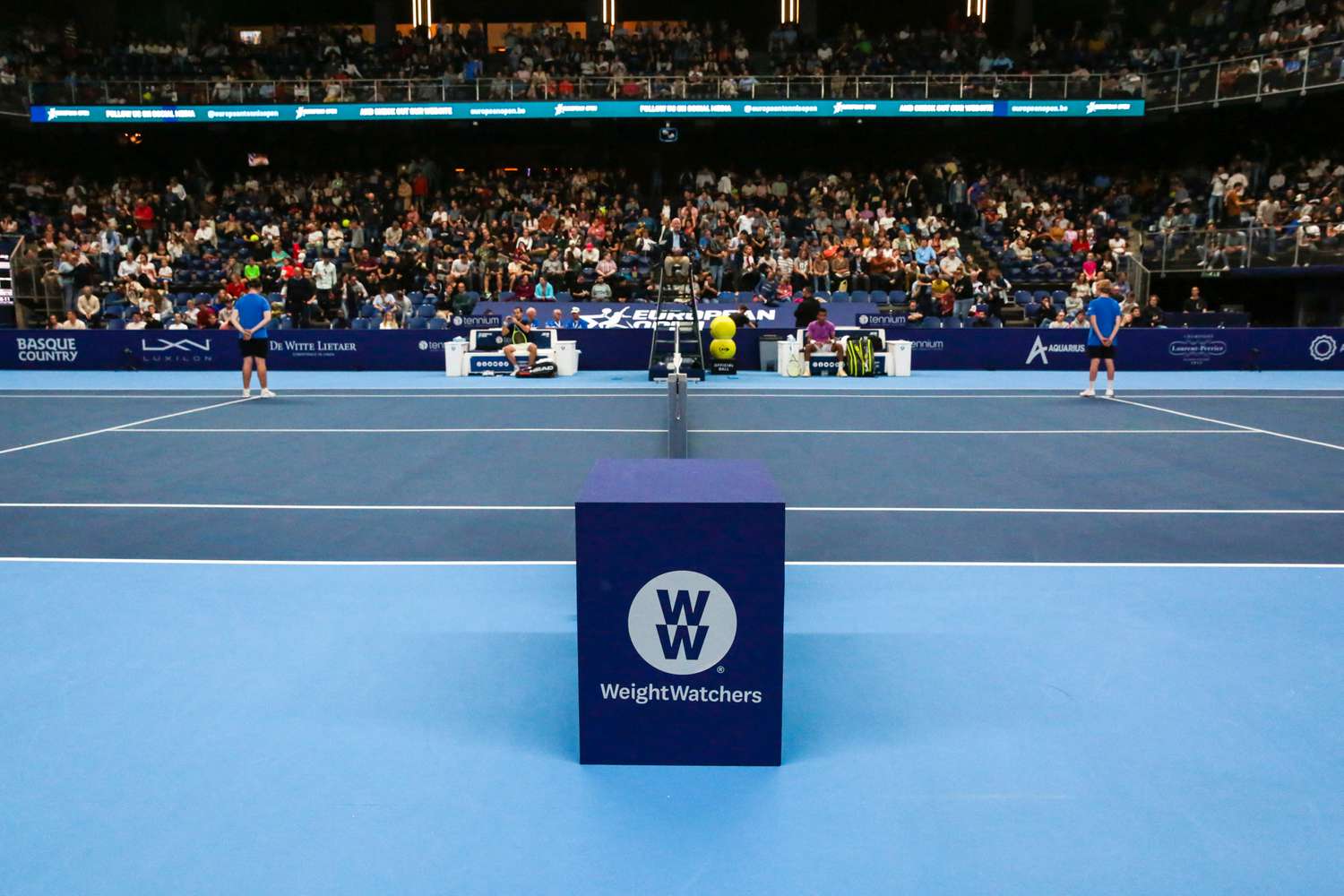 The WeightWatchers logo is seen on the side of a box on a tennis court.