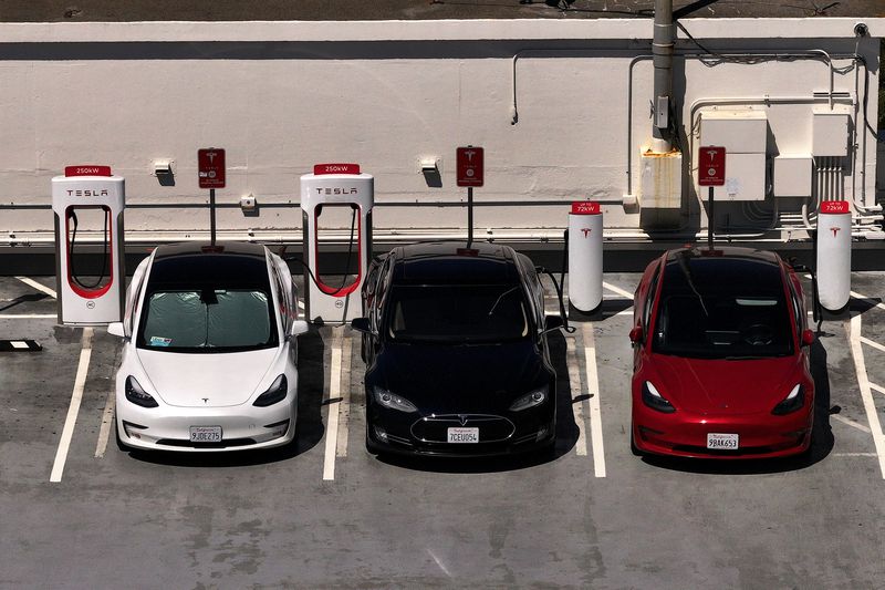 Tesla cars sit parked at a charging station on May 19, 2025 in San Francisco, California