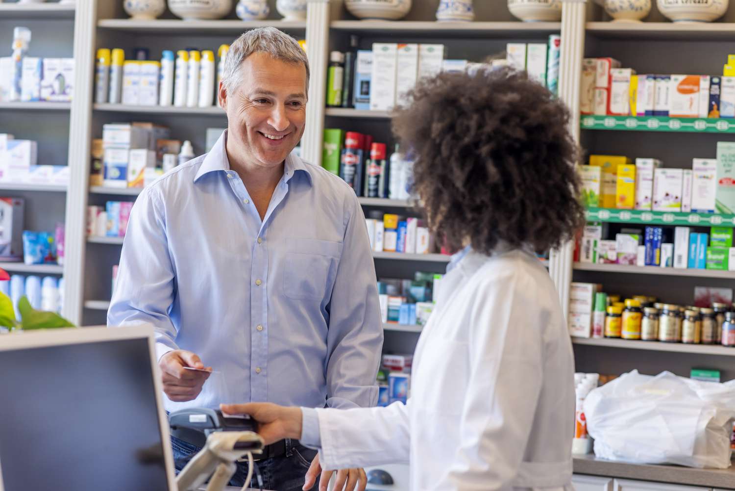 Man pays for a medicine at a pharmacy