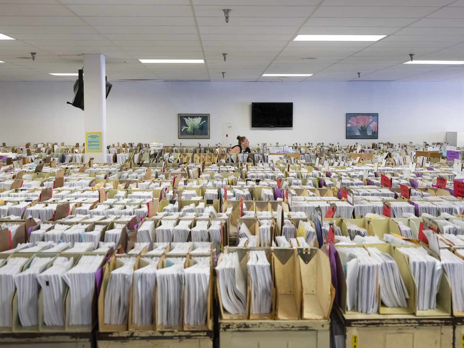 Margaret Moore, an IRS clerk, searches through taxpayer documents that have been stored in the IRS cafeteria due to a lack of space at the Internal Revenue Service in Austin, Tx., on Friday, June 10, 2022.