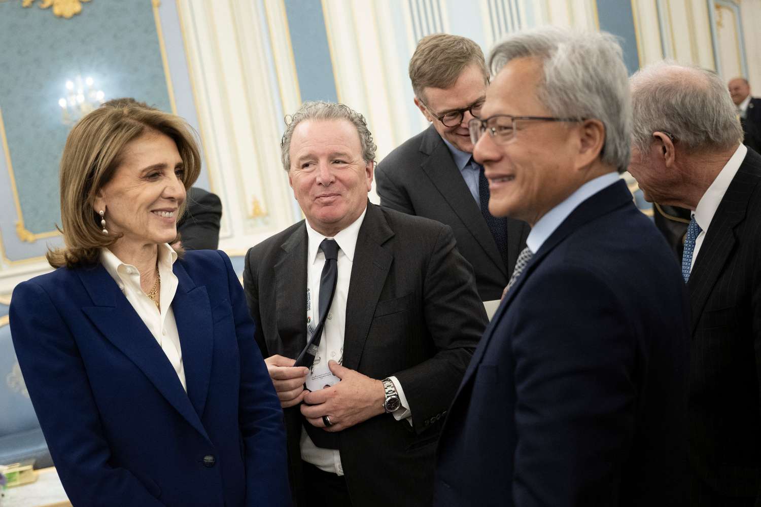 Alphabet chief investment officer Ruth Porat (L) and Nvidia CEO Jensen Huang (R) wait to meet the Saudi Crown Prince at the Royal Court in Riyadh on May 13, 2025. 