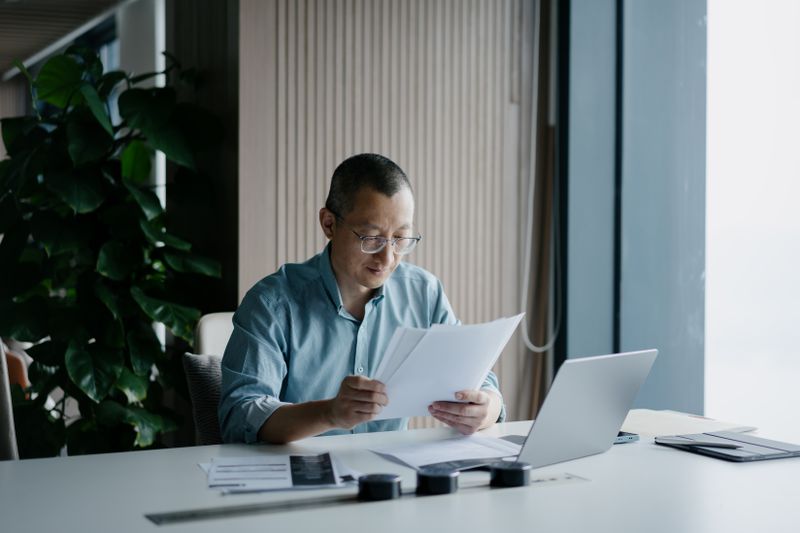 Loan officer looks through applications for payday loan.