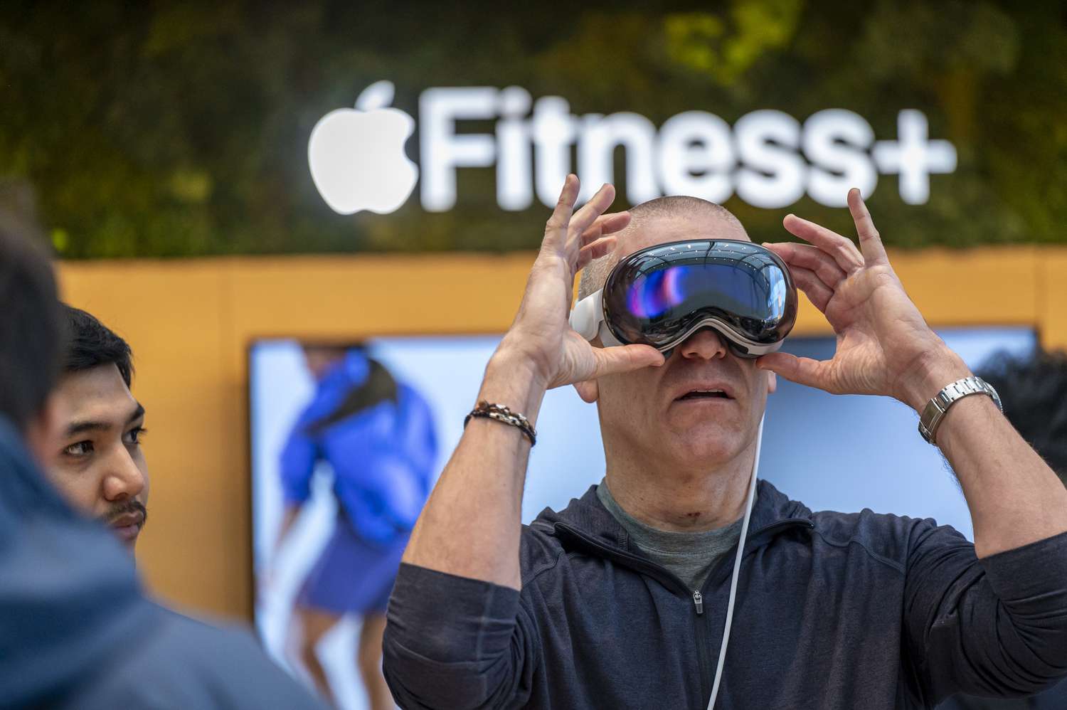 A customer with an Apple Vision Pro mixed reality (XR) headset at the company's store in Palo Alto, California, US, on Friday, Feb. 2, 2024. 