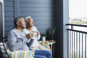Senior couple relaxing outside on balcony