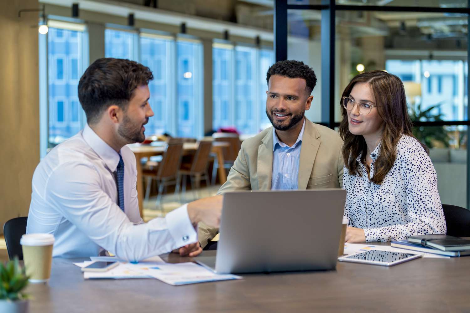 Financial advisor explains to a couple of homeowner about the concept of first mortgage.