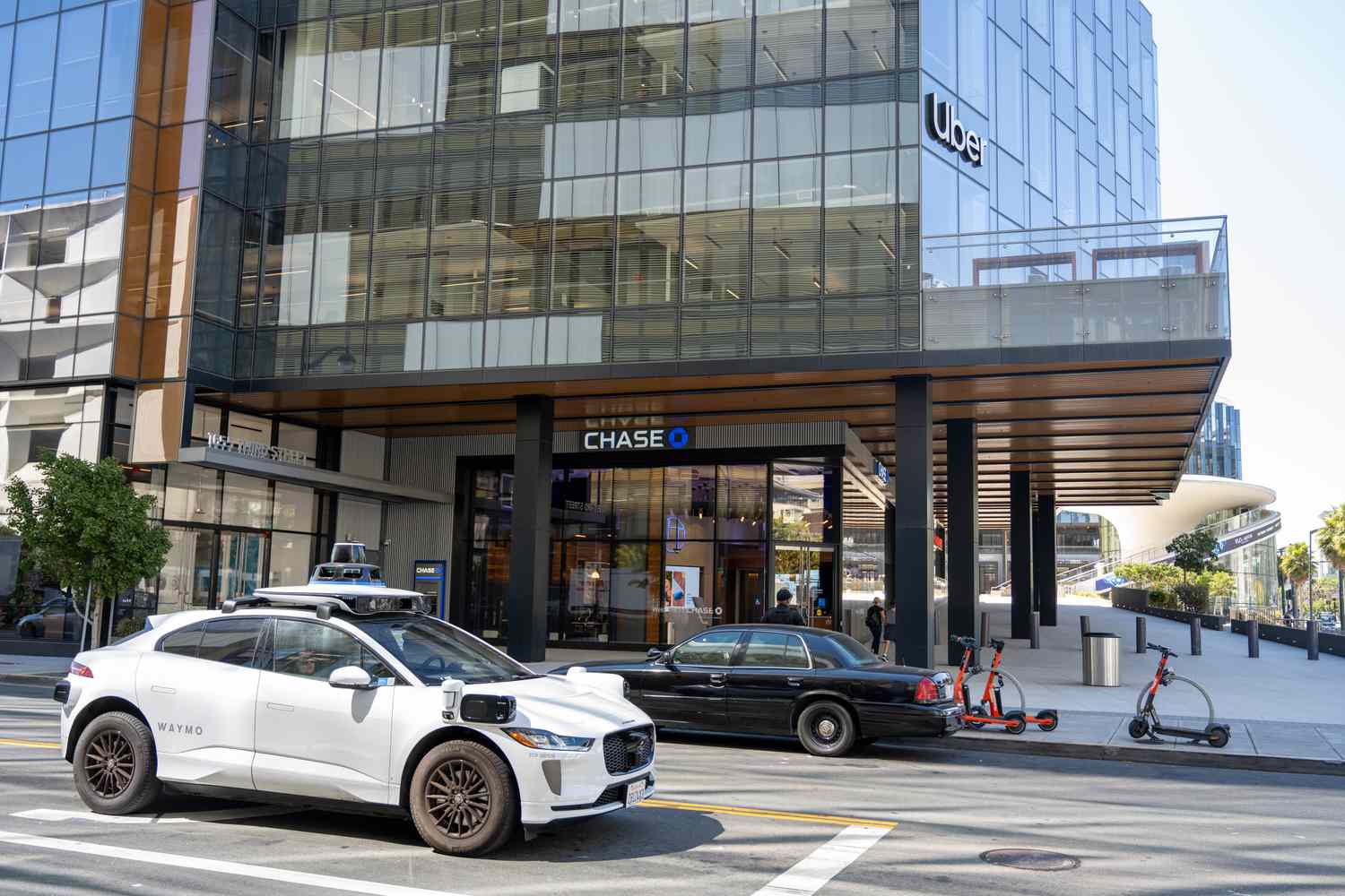 Waymo self-driving car parked in front of Uber headquarters building in San Francisco, California on Aug. 20, 2024.