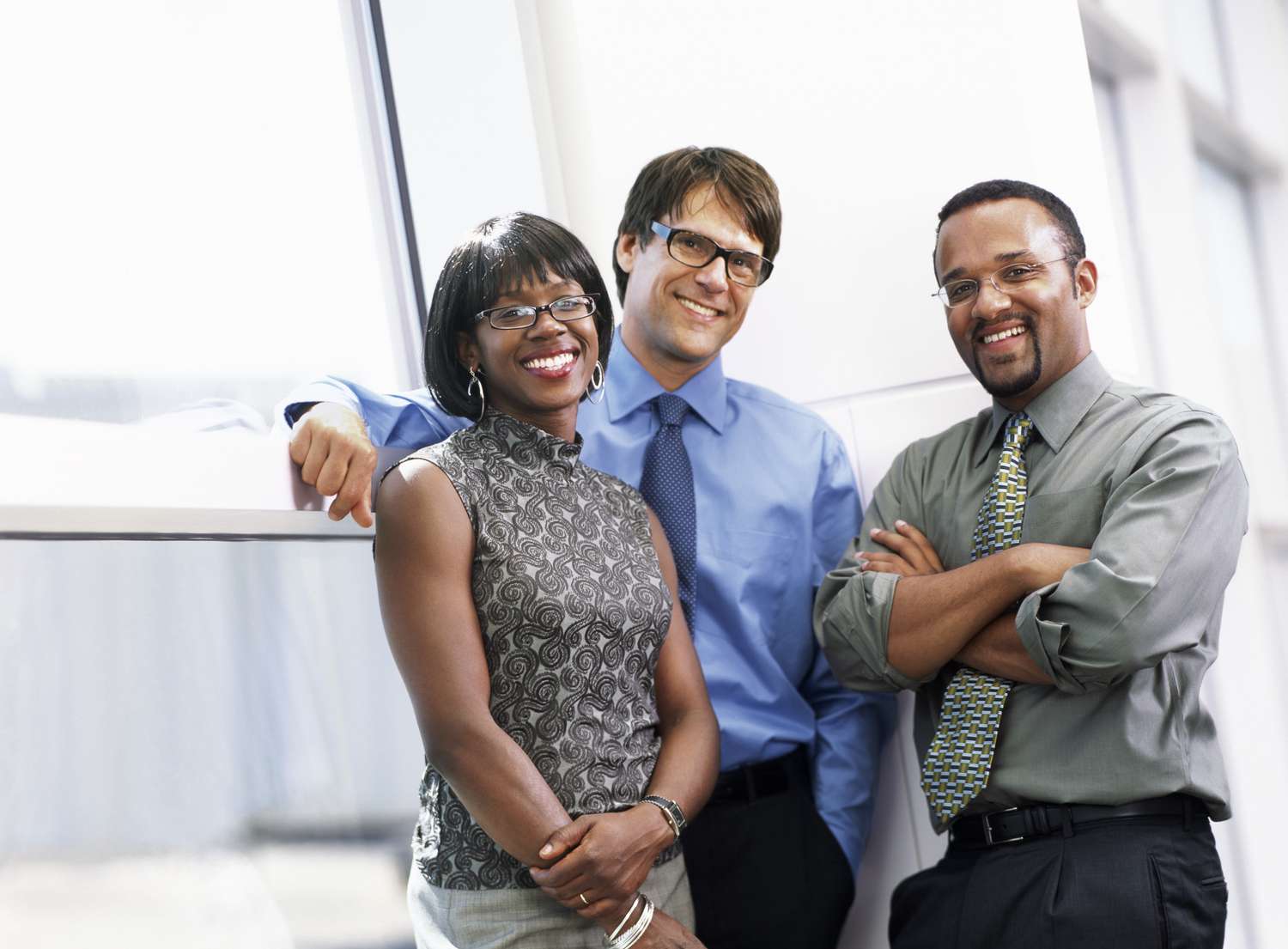 Group of three business people smiling at camera