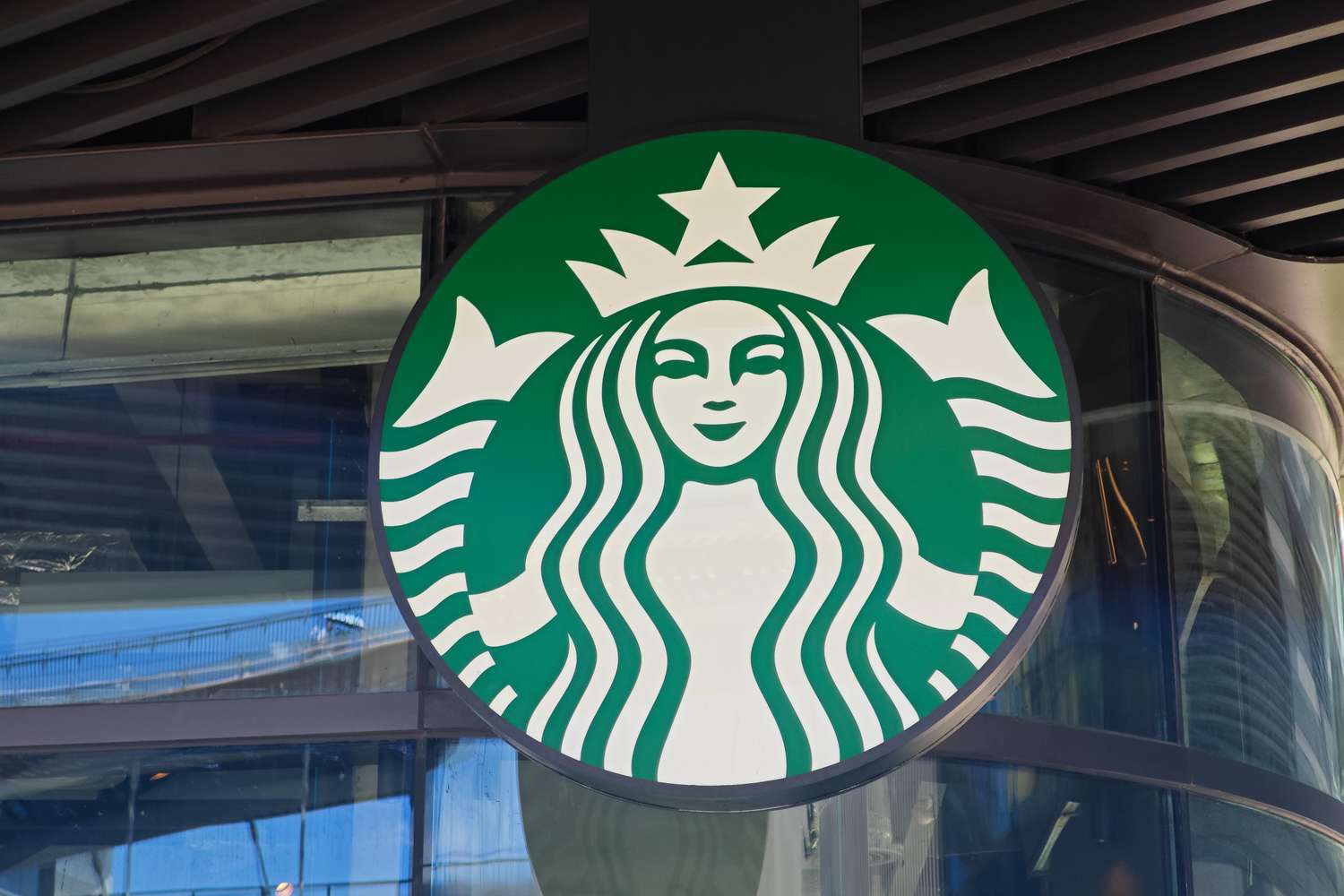 Close-up of a Starbucks logo on a building's facade.
