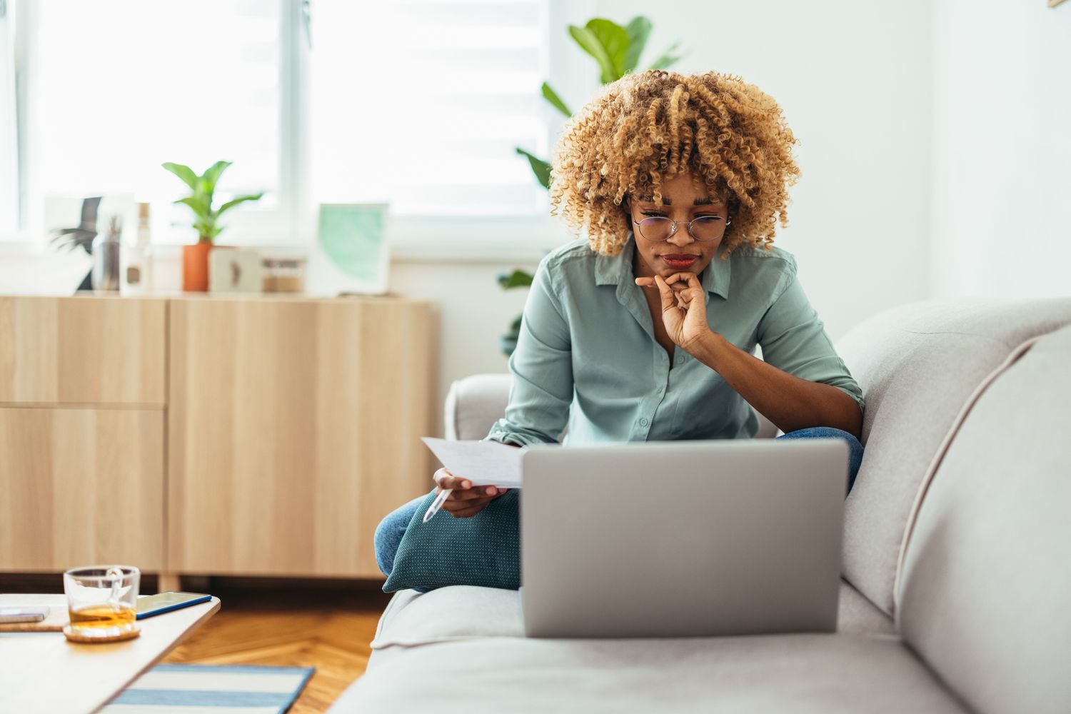 Worker studying laptop on a couch