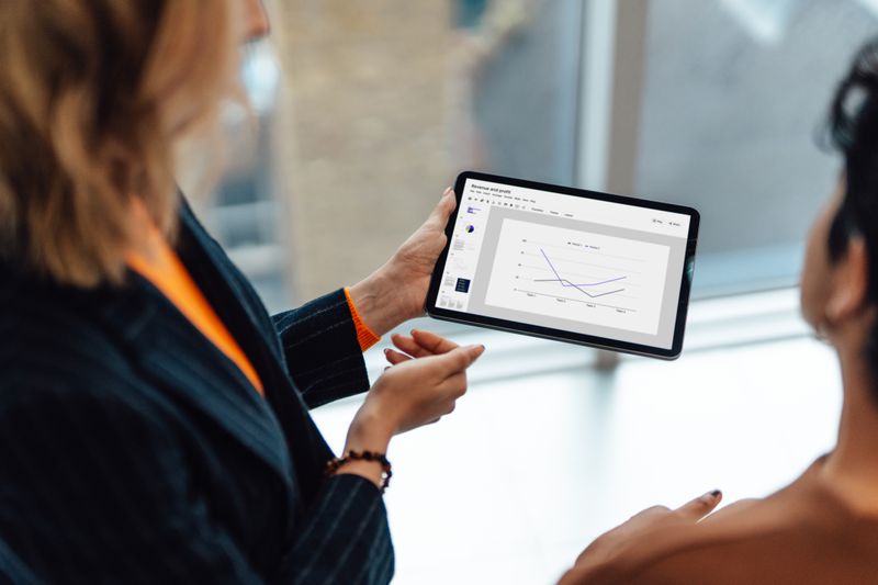 Two women looking at a chart on a tablet