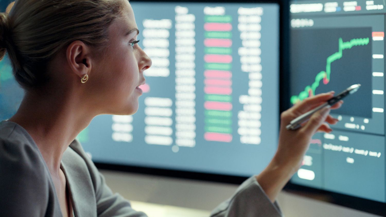 An investor looks at a rising stock chart on a computer monitor