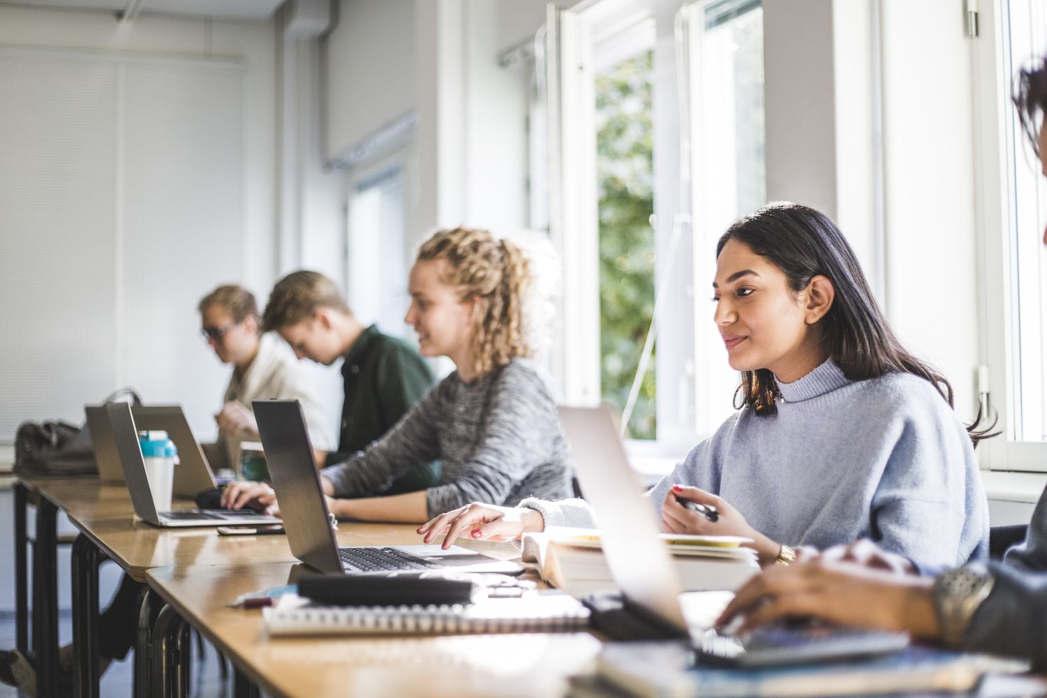 College students in class use lap tops.