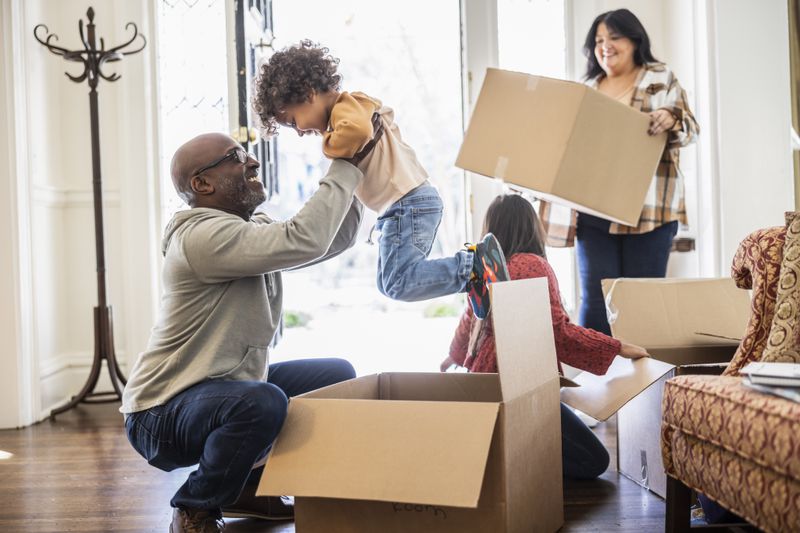 A family unpacking moving boxes