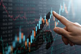 Finance analyst pointing at a technical analysis chart