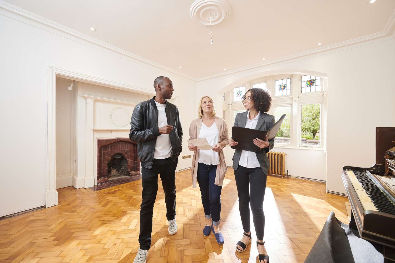 an estate agent shows a couple around a refurbished period home