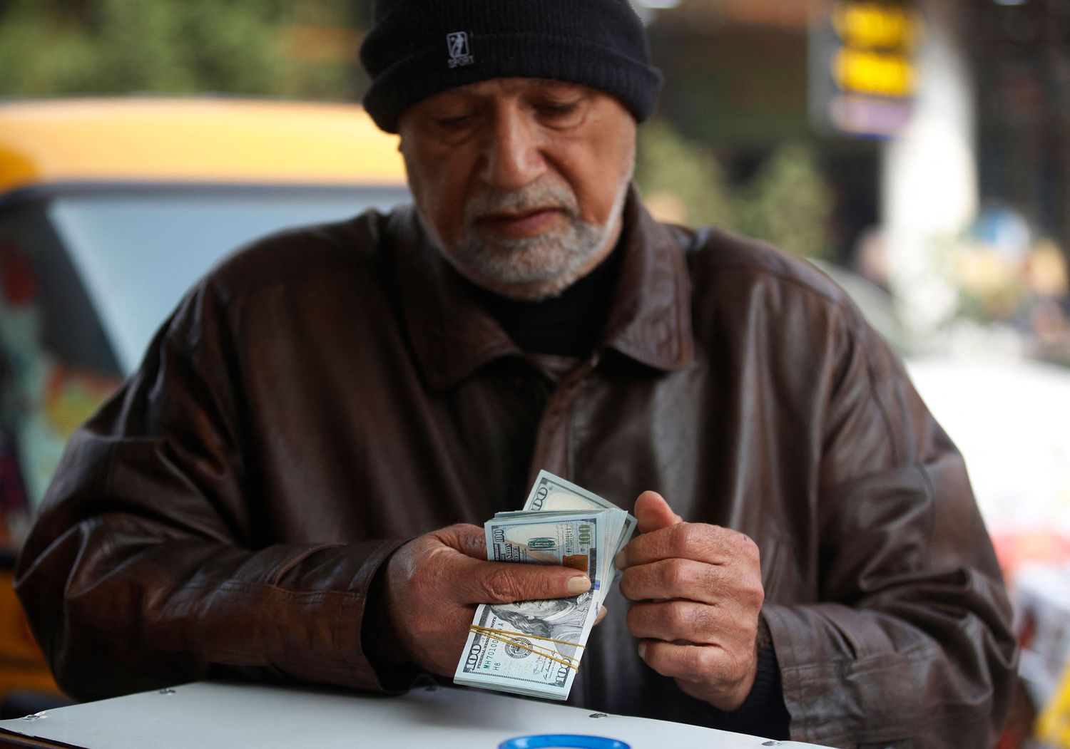 Person counting US dollar bills