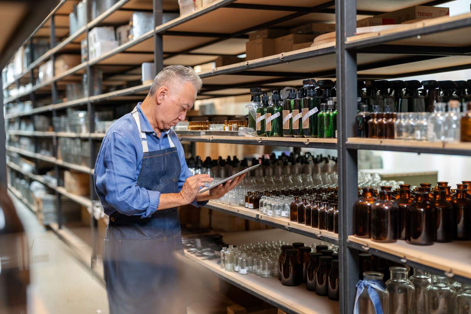 Person in a warehouse taking inventory of stock