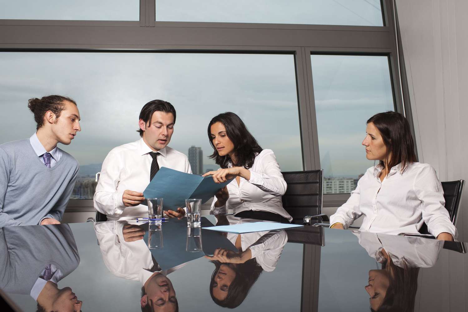 A group of people looking at a folder