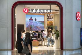 People walk near a Lululemon store. 