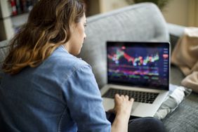 Person viewing stock market data on a laptop