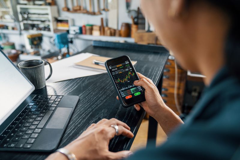 Man looking at his smartphone to monitor his cryptocurrency.