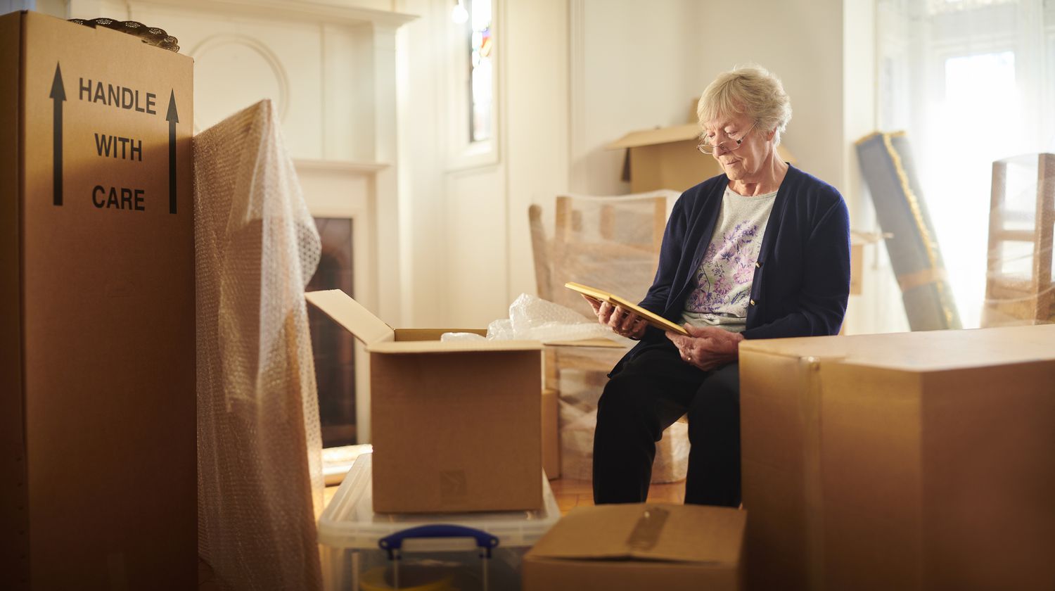 Senior woman packing up her house before moving.
