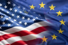 A closeup view of the flags of the European Union and the United States merging together.