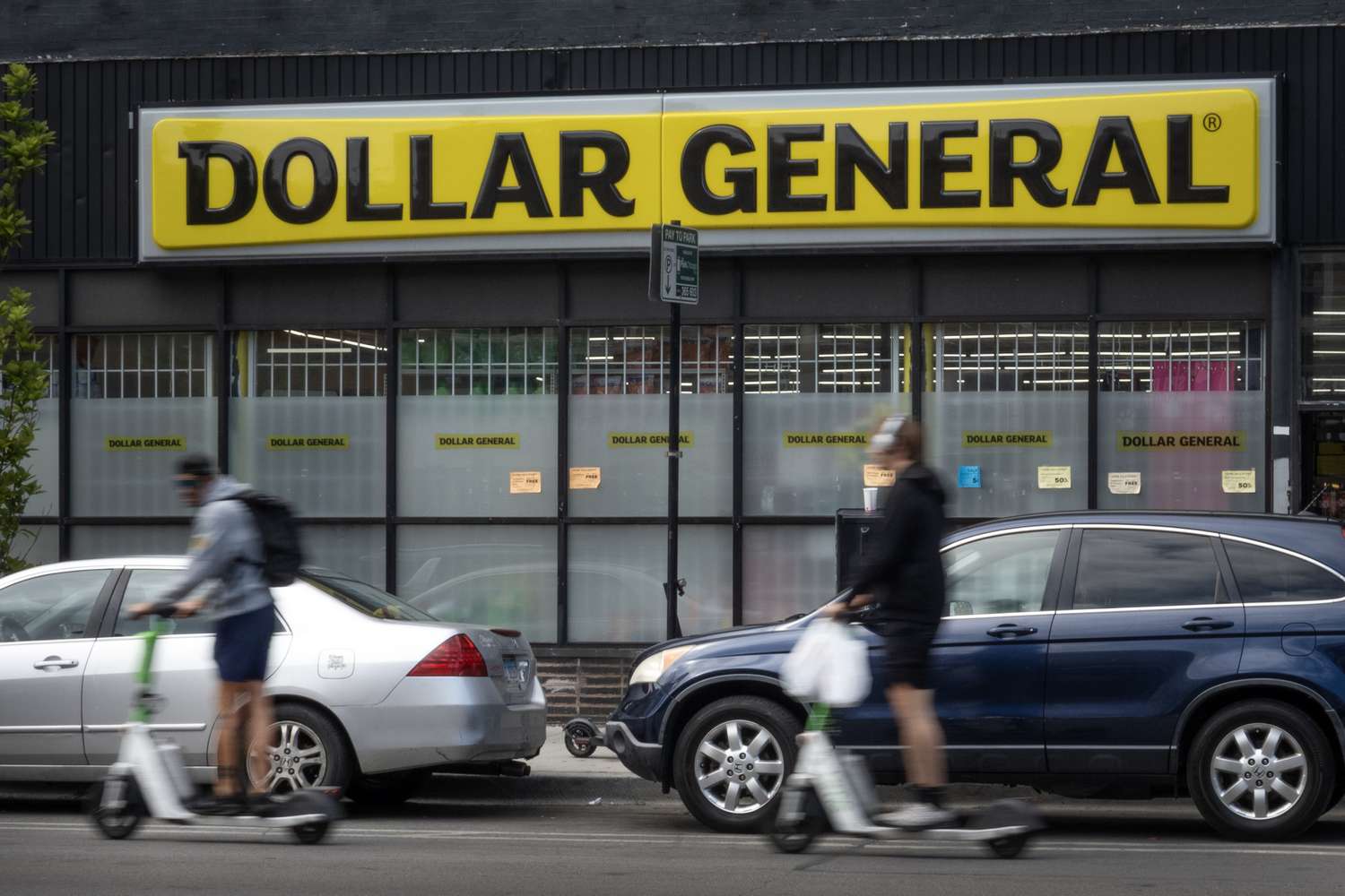 People and cars are seen in front of a Dollar General store in Chicago.