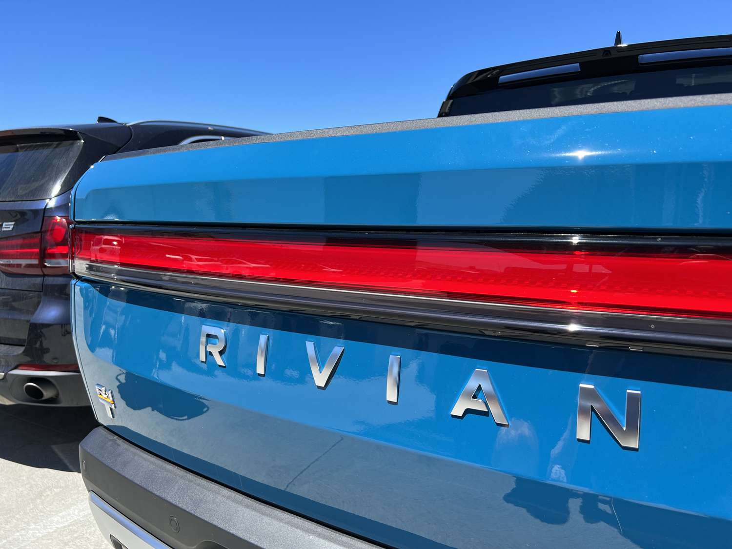 Close-up of logo for electric vehicle company Rivian on a vehicle.
