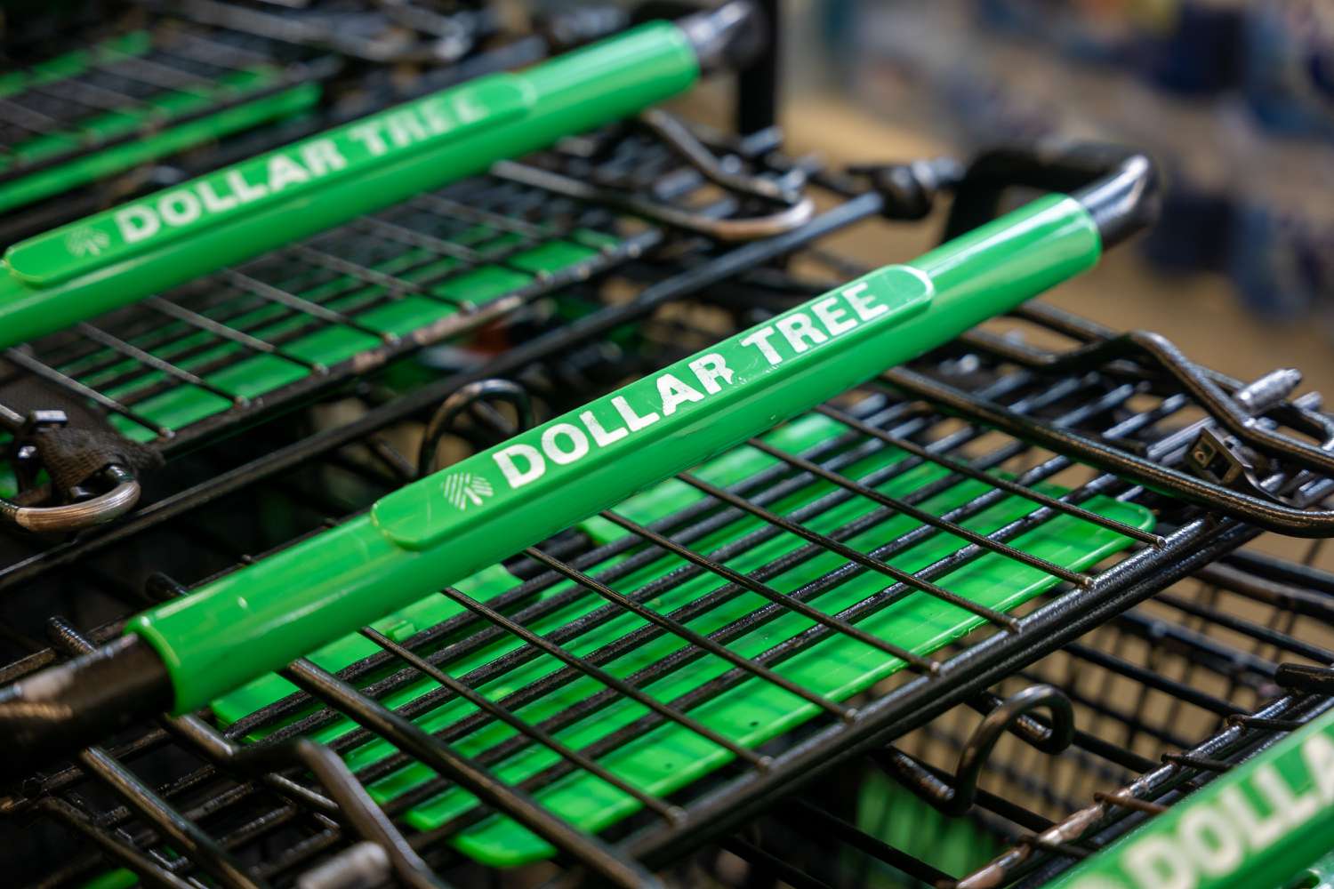 The Dollar Tree logo is seen on a group of green and black shopping carts