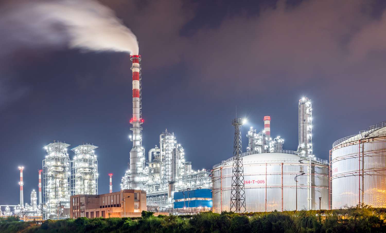 A refinery at dusk, lit up and running