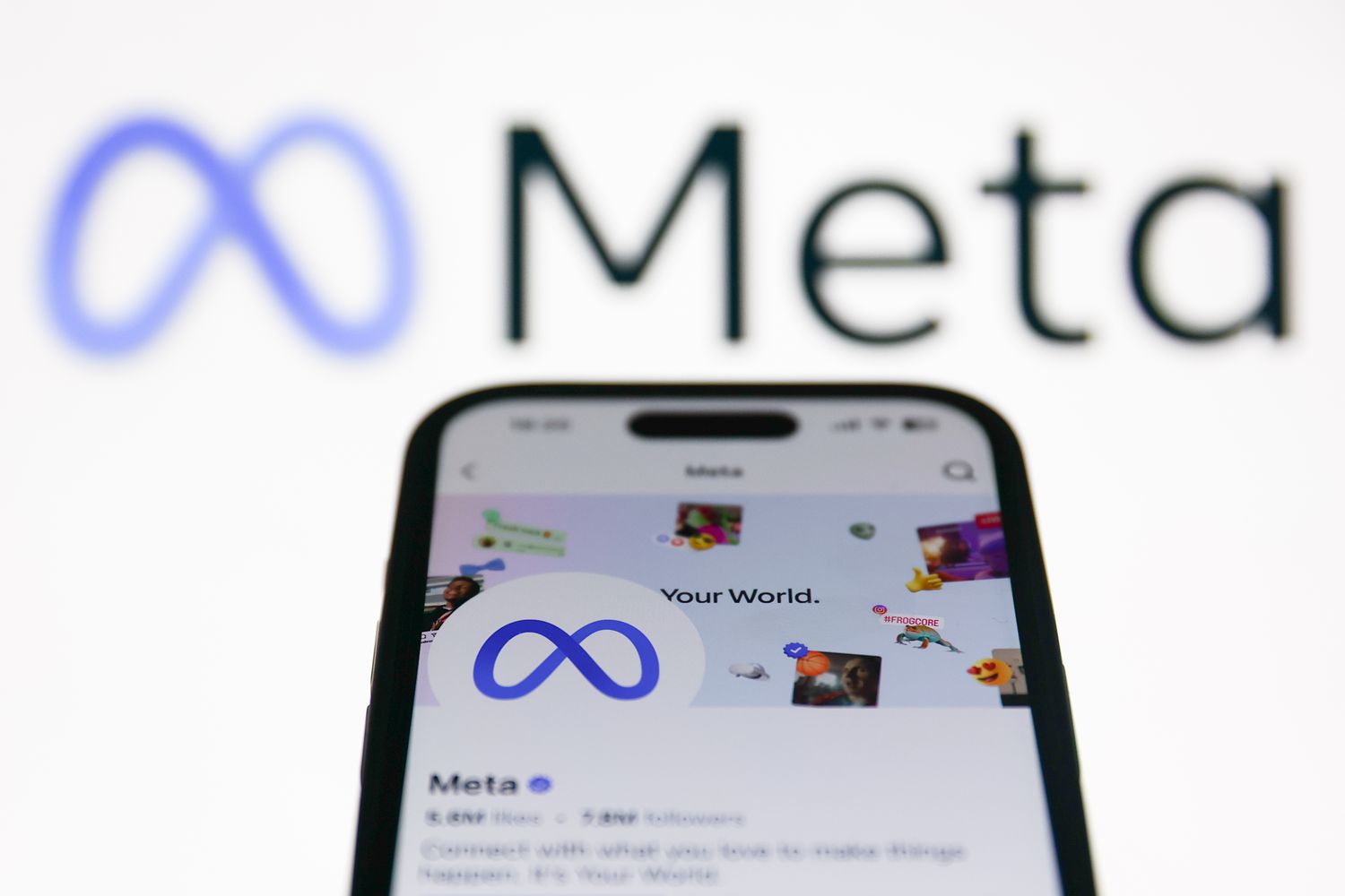 Meta logo displayed on a laptop screen and Meta account on Facebook displayed on a phone screen 