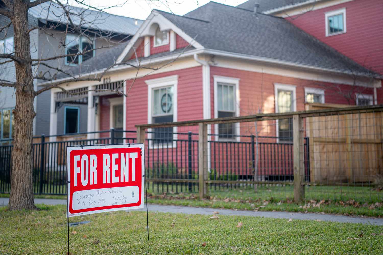 A "For Rent" sign is in the yard outside of a home in Texas. 