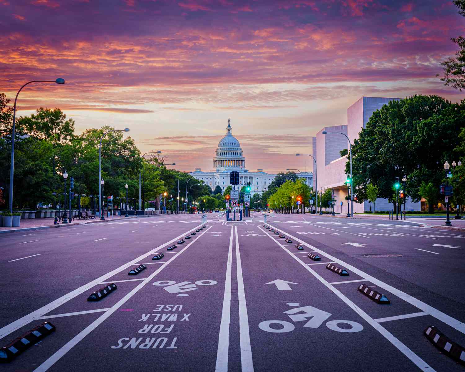 Sunrise on Pennsylvania Avenue with no cars on the road and the capital in the background