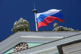 The Russian flag flying on top of the State Hermitage Museum