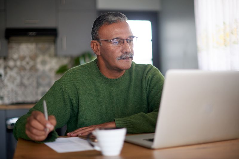 Person in Green Sweater Writes Down Best Investment Options