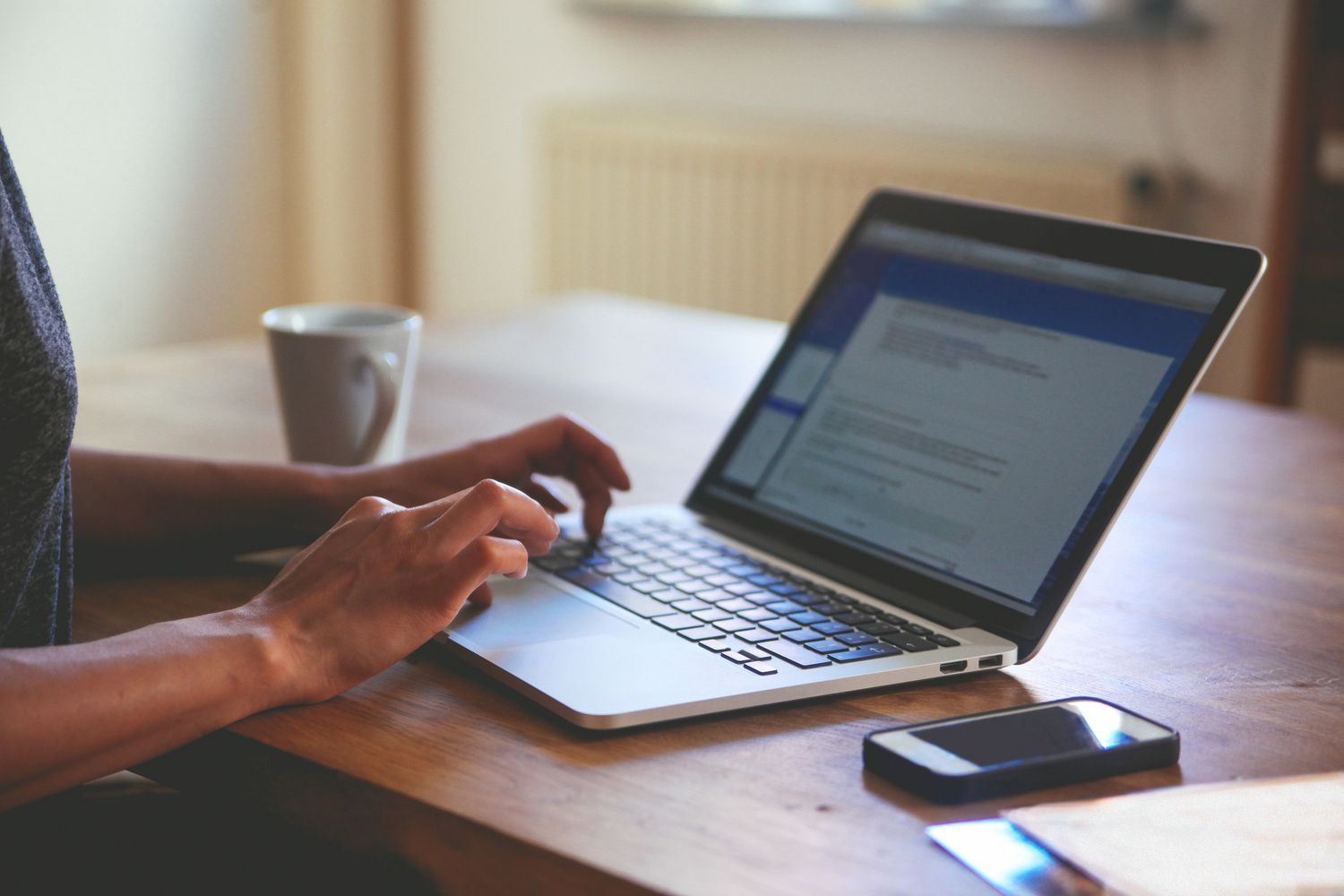 Person writing on laptop