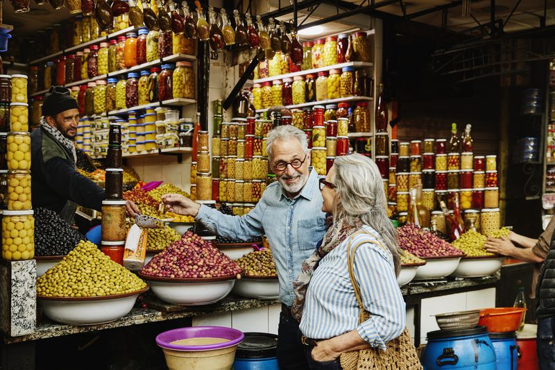 Two elderly people in an olive market in Morocco.