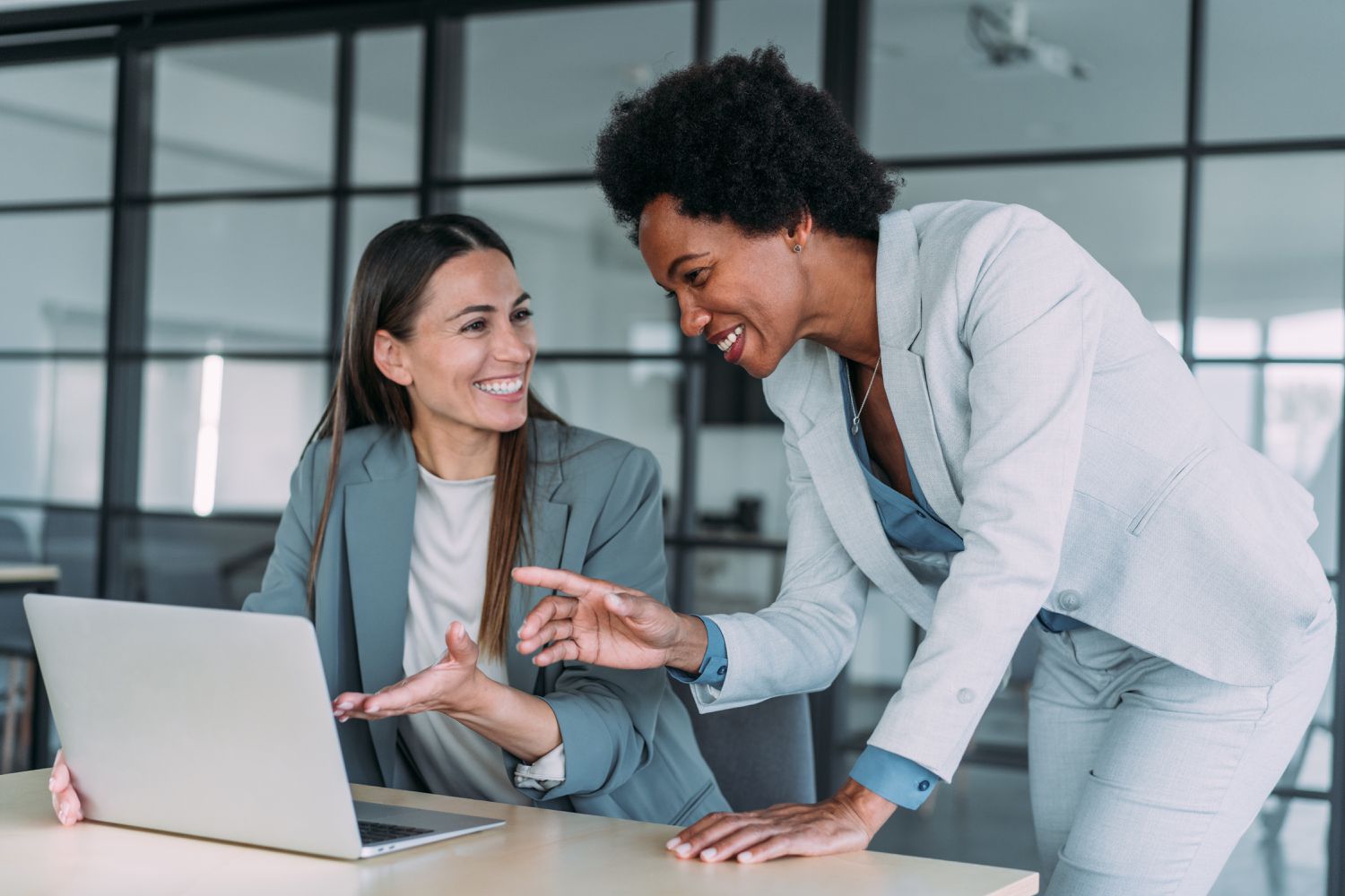 Two women discussing something on a computer