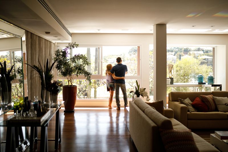 Couple admiring the view from the living room of their house