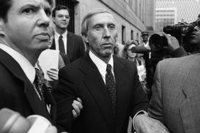 Ivan Boesky, surrounded by a crowd of people, leaves a courthouse after pleading guilty to a count of conspiracy.