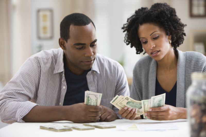 Couple calculating the difference between their disposable incomes and discretionary incomes