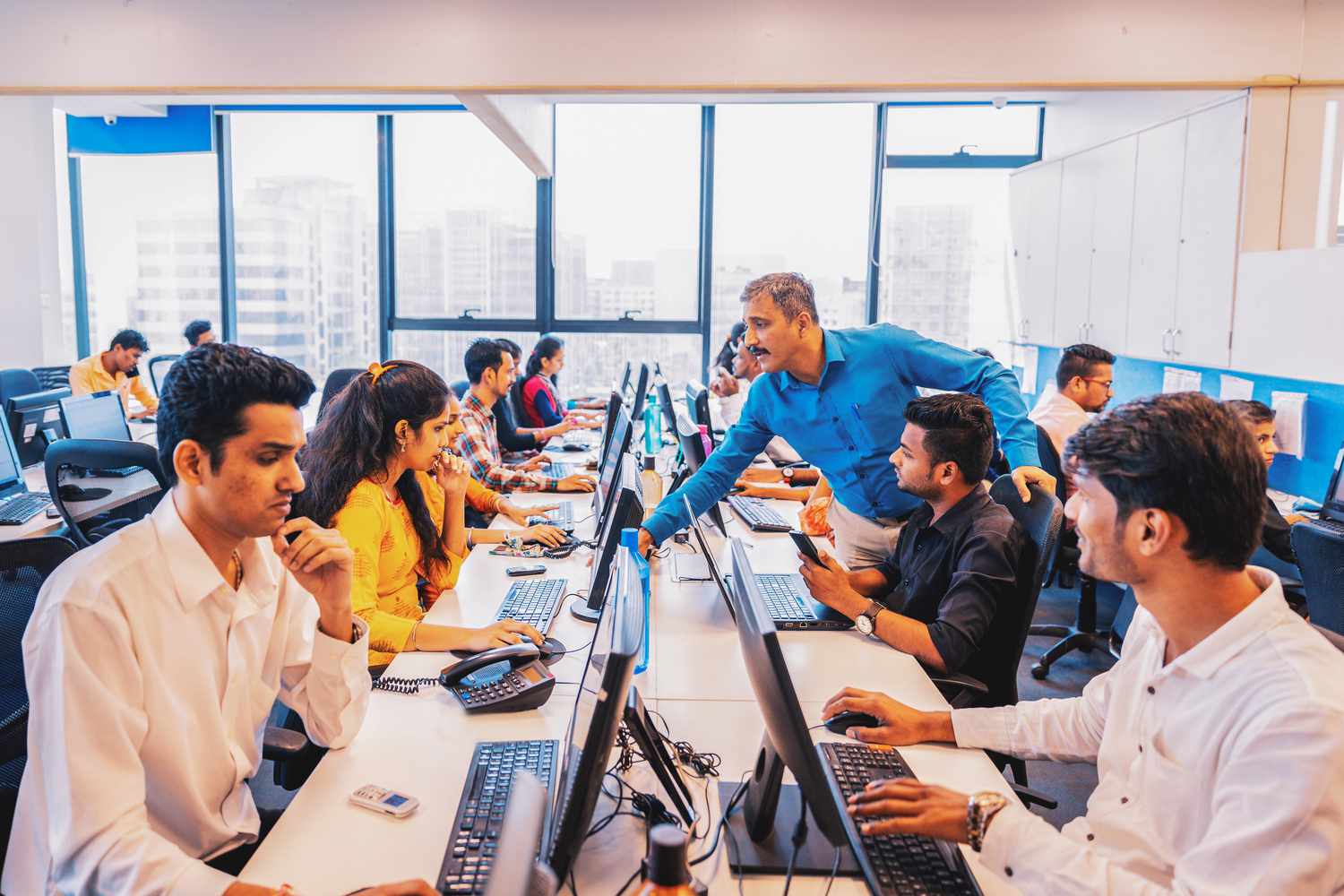 Group of Business Executives working along side each other in a call centre