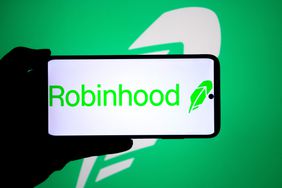 A Robinhood logo seen displayed on a smartphone and in the background