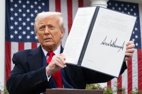 Donald Trump holding up a signed document
