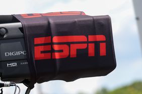 The ESPN logo is seen on a black sleeve around a television camera.