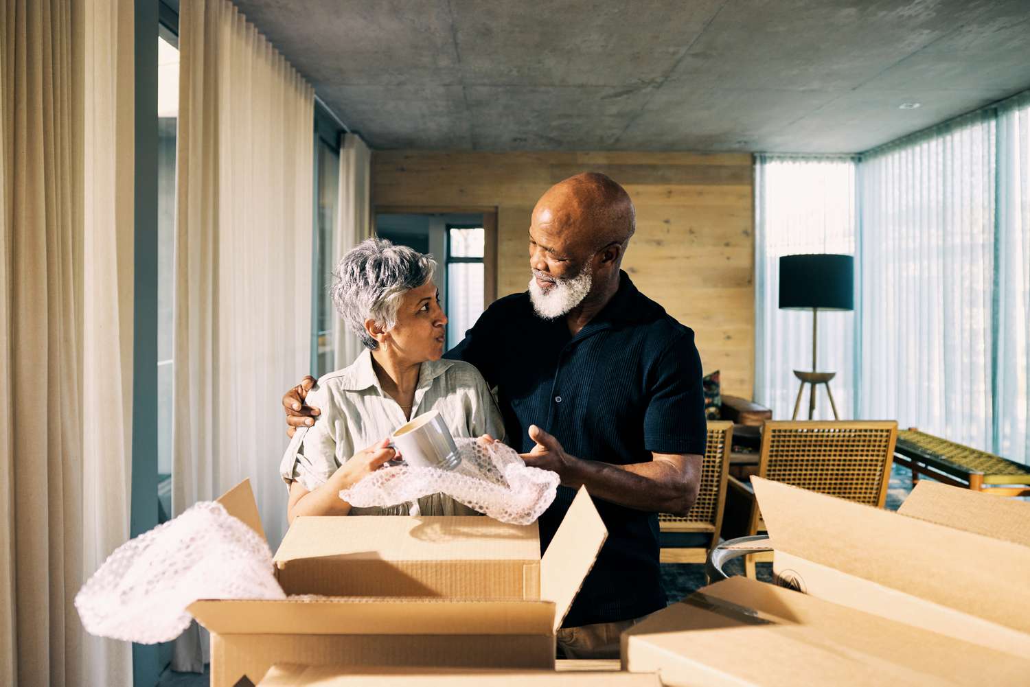 couple unpacking boxes after moving into a home