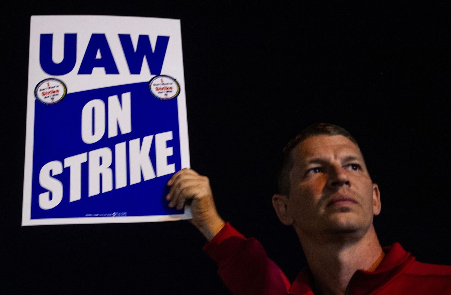 United Auto Workers members picket outside of a Ford assembly plant. 