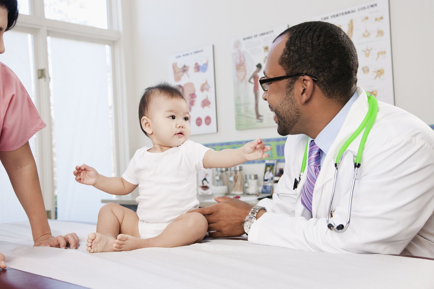 Doctor and nurse examining baby in doctor's office