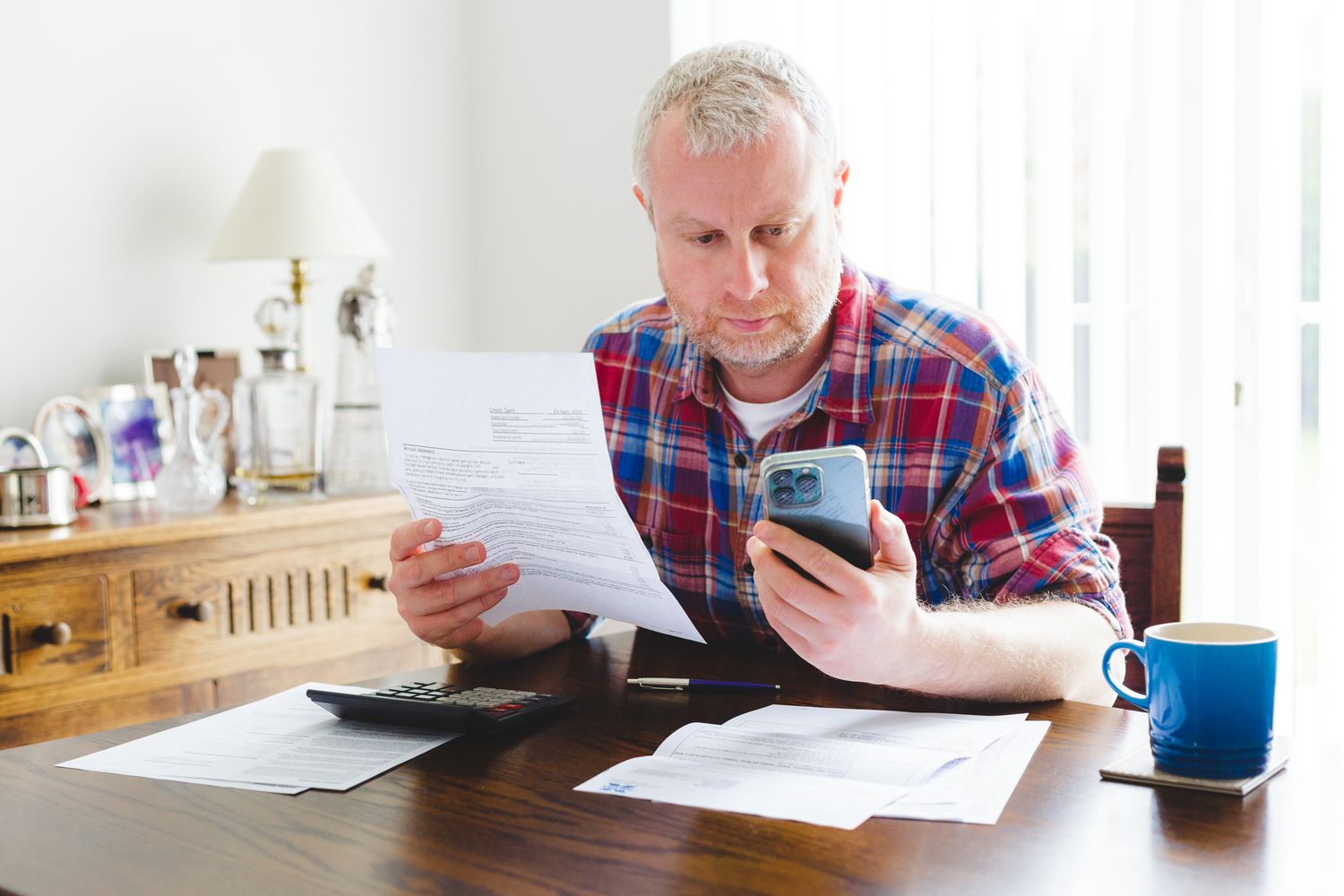 An adult checking Credit Karma as a replacement for Mint - a free budget app.